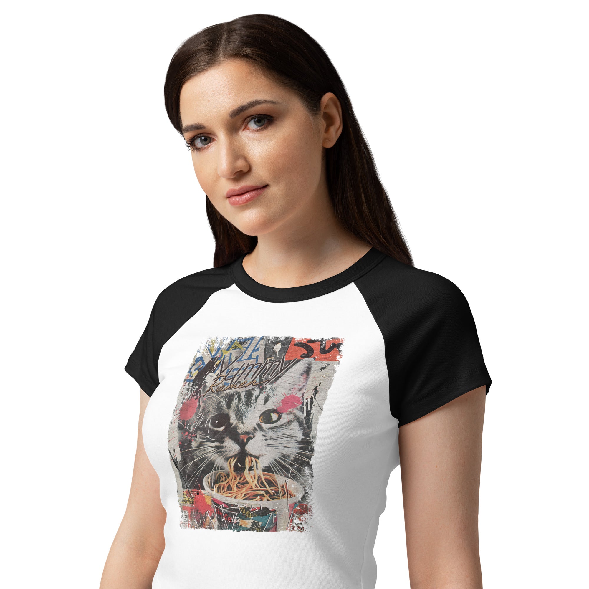 Woman wearing a white and black raglan baby tee with a cat eating ramen noodles graphic.