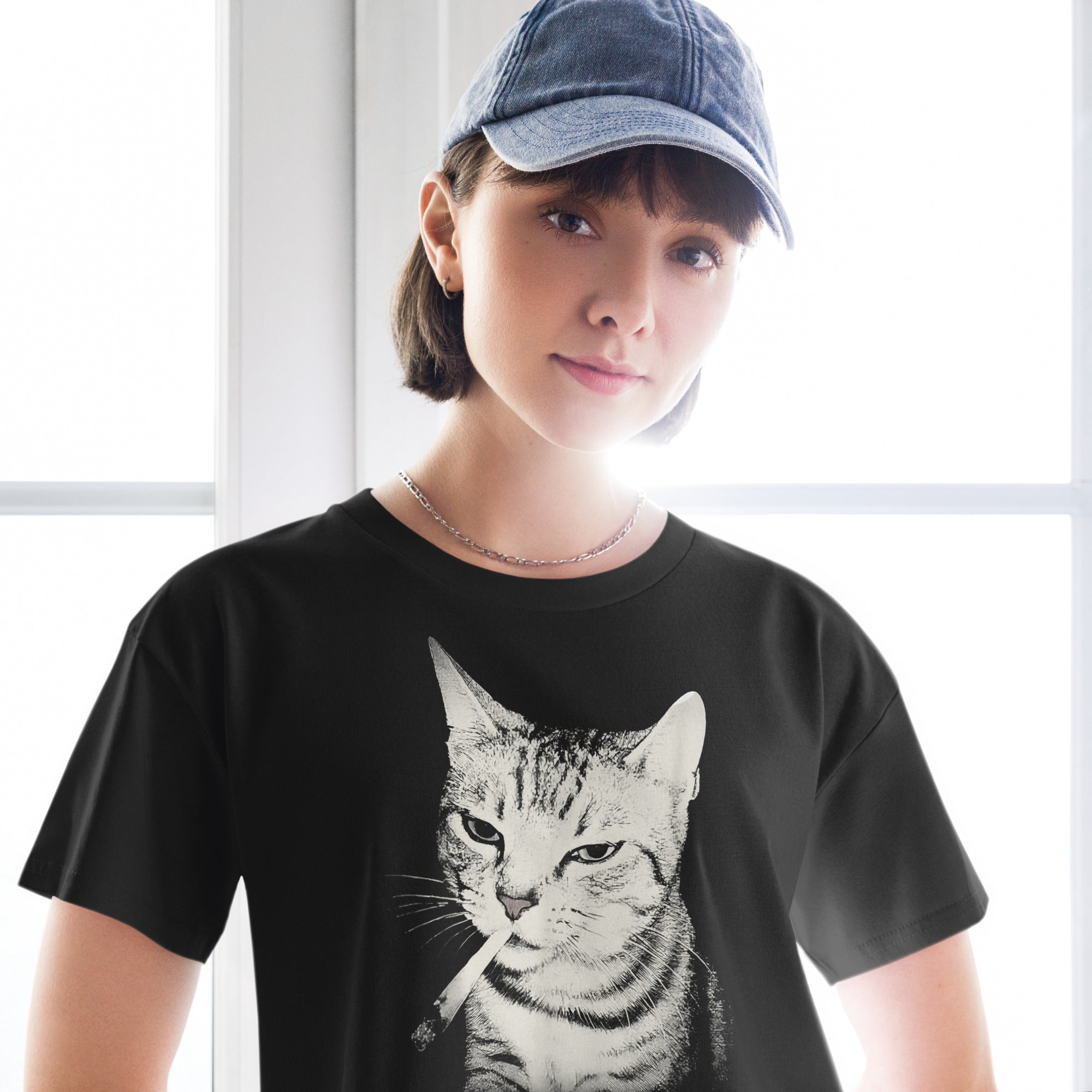 woman wearing a black t-shirt with a vinatge graphic of a cat smoking cigarette